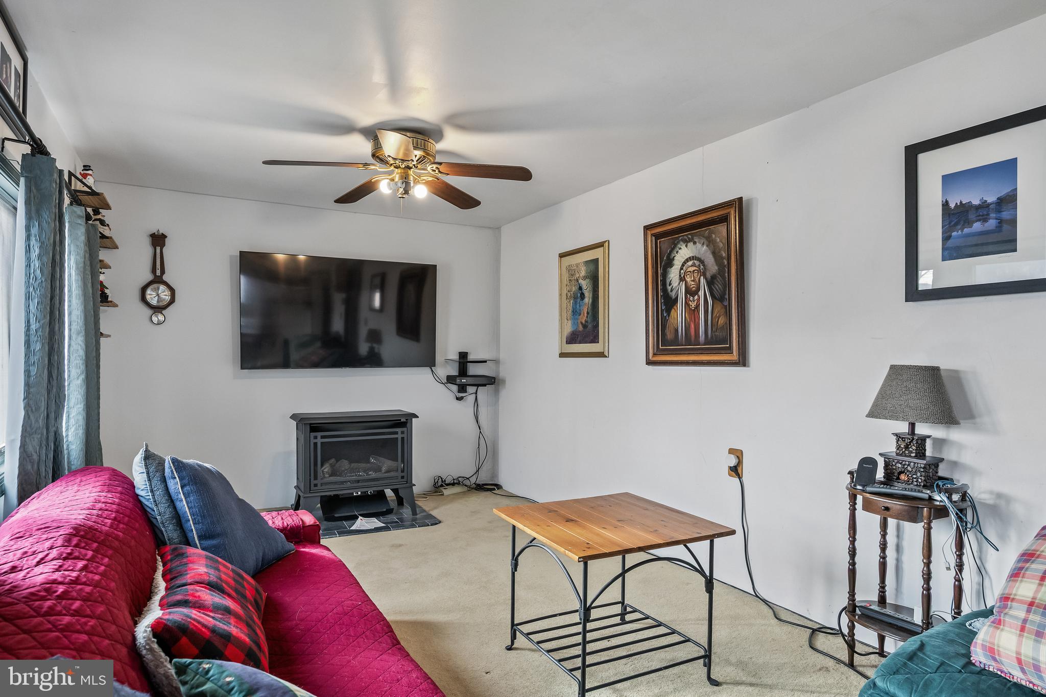 710 Cooper Street Florence, NJ 08518 - Photo 11 of 27 a living room with furniture a flat screen tv and a fireplace