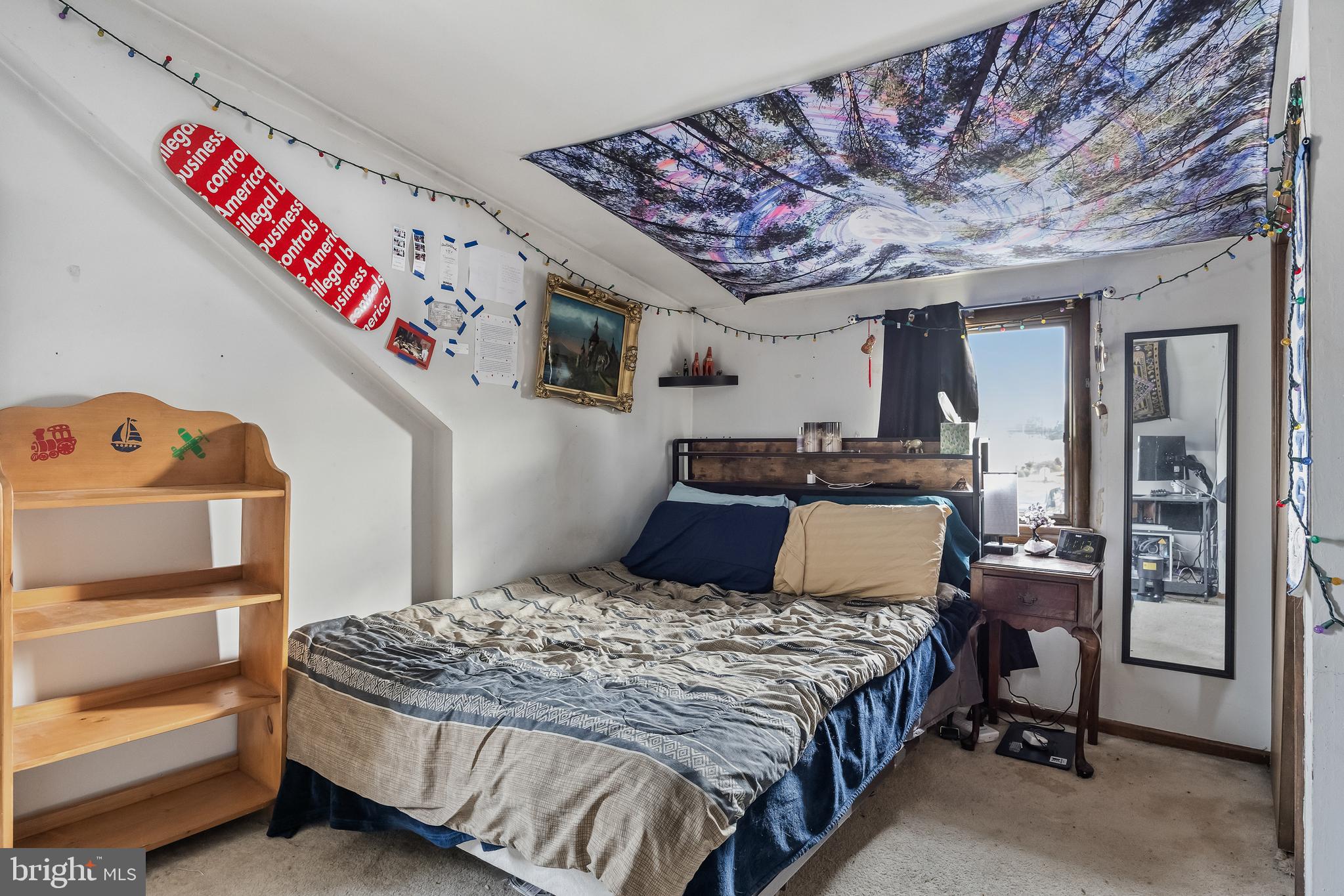 710 Cooper Street Florence, NJ 08518 - Photo 18 of 27 a bedroom with a bed and a chandelier