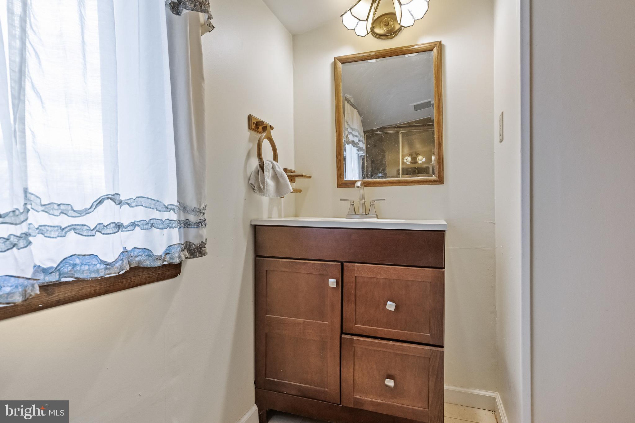 710 Cooper Street Florence, NJ 08518 - Photo 21 of 27 a bathroom with a sink a mirror and vanity