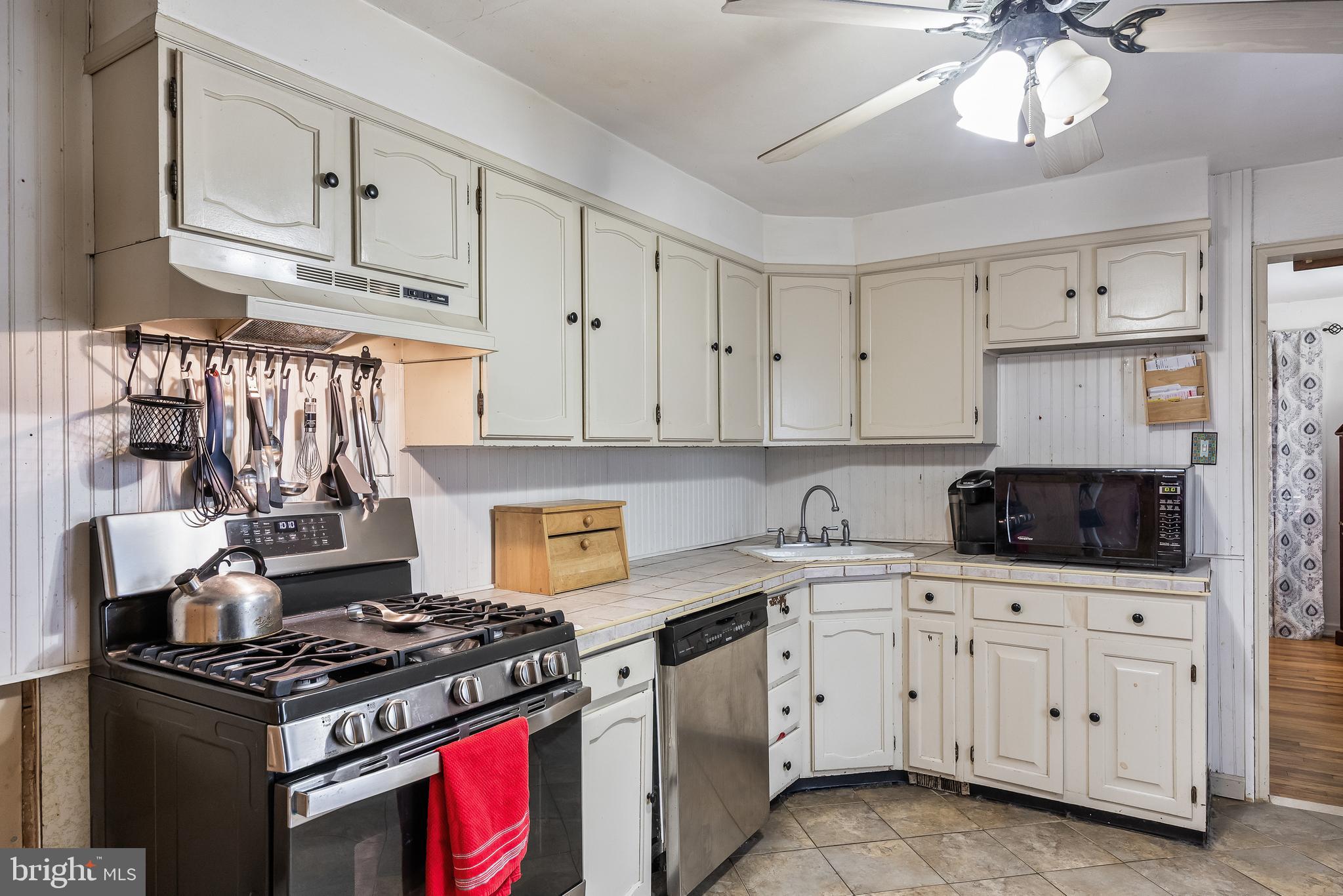 710 Cooper Street Florence, NJ 08518 - Photo 7 of 27 a kitchen with white cabinets and appliances
