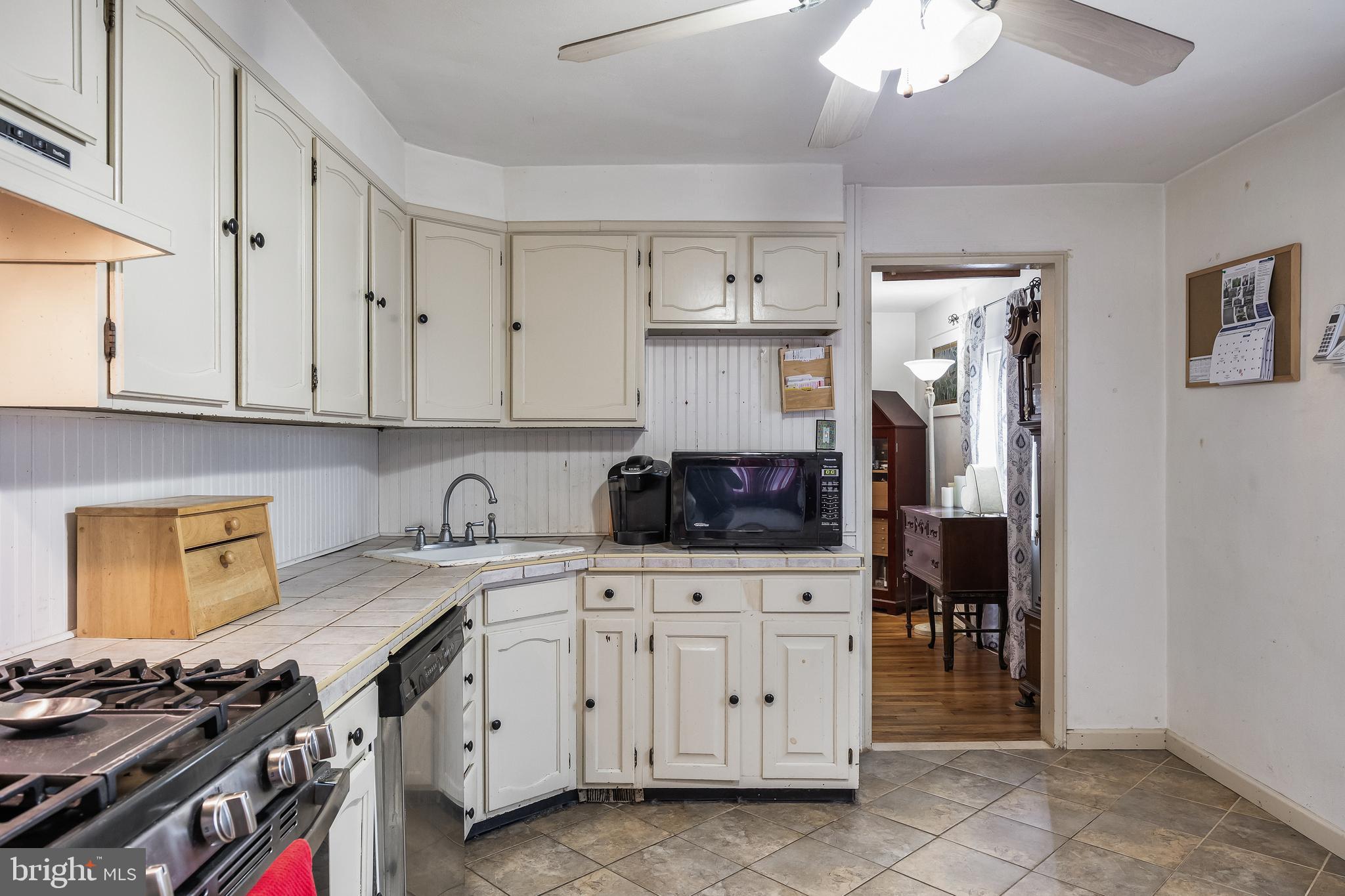 710 Cooper Street Florence, NJ 08518 - Photo 8 of 27 a kitchen with white cabinets and appliances