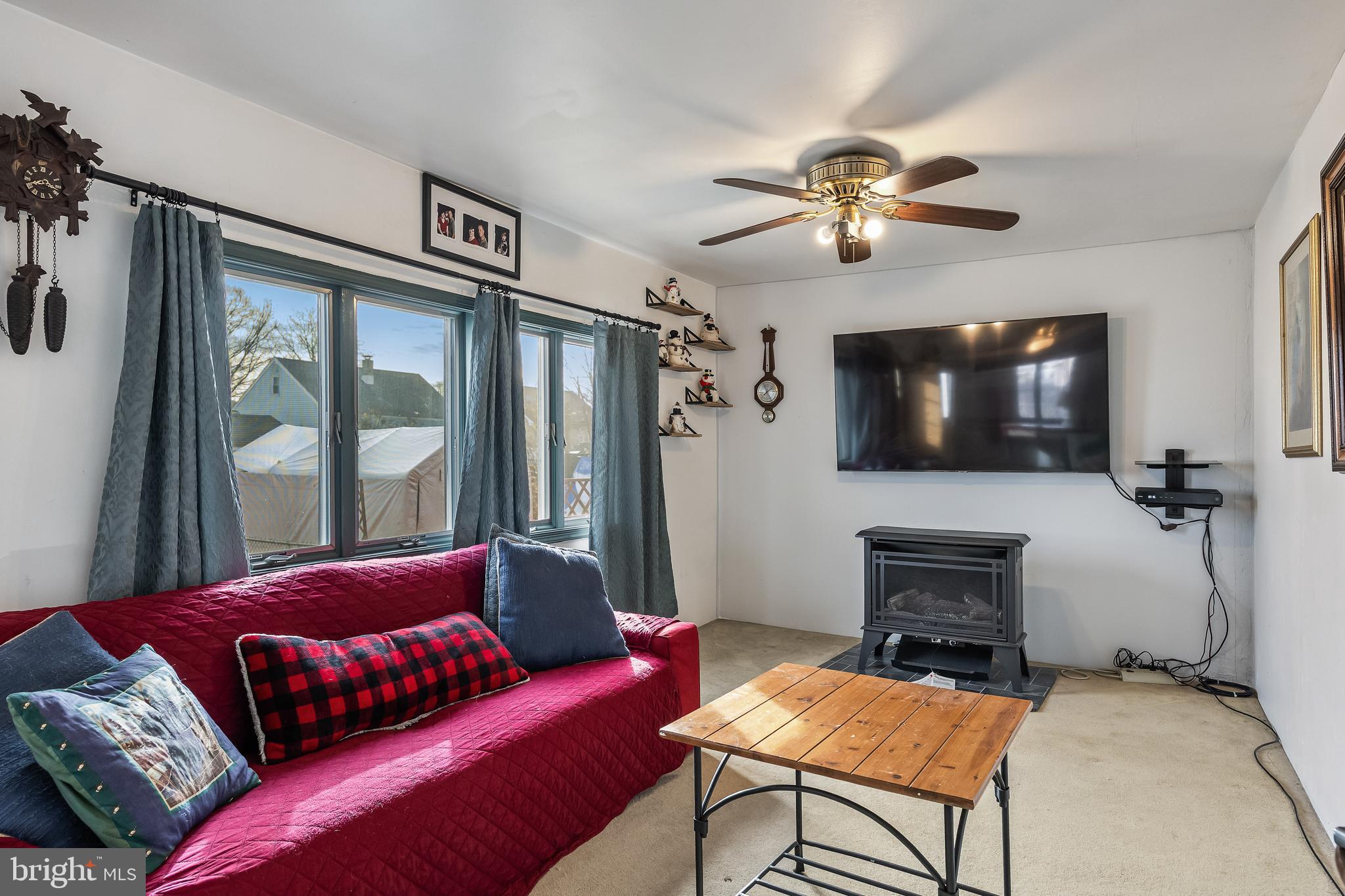 710 Cooper Street Florence, NJ 08518 - Photo 10 of 27 a living room with furniture a ceiling fan and a flat screen tv