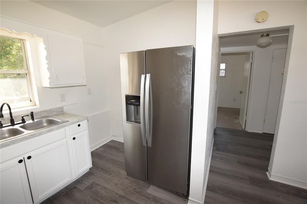 104 West Lancaster Road Orlando, FL 32809 - Photo 12 of 24 a kitchen with a refrigerator sink and cabinets