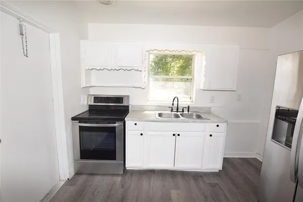 a kitchen with a sink stove and refrigerator