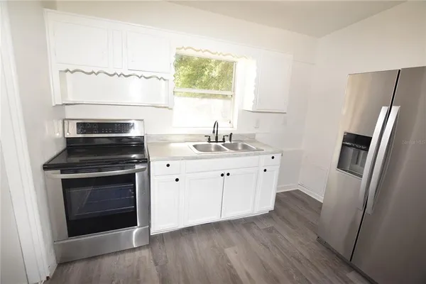 a kitchen with a sink stove and refrigerator