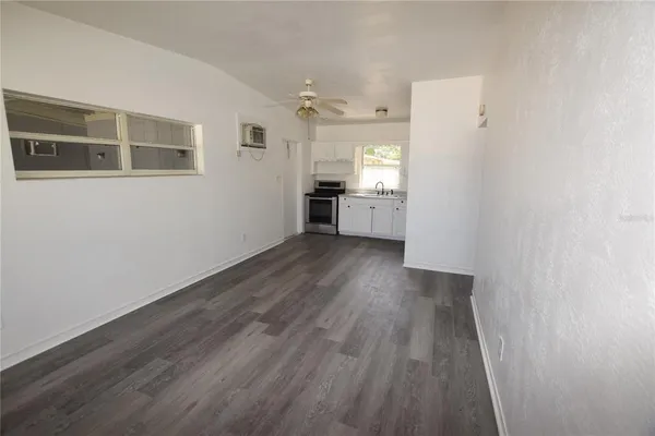 a view of a kitchen with wooden floor and a sink