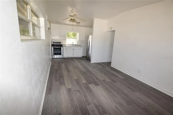 wooden floor in an empty room with a window