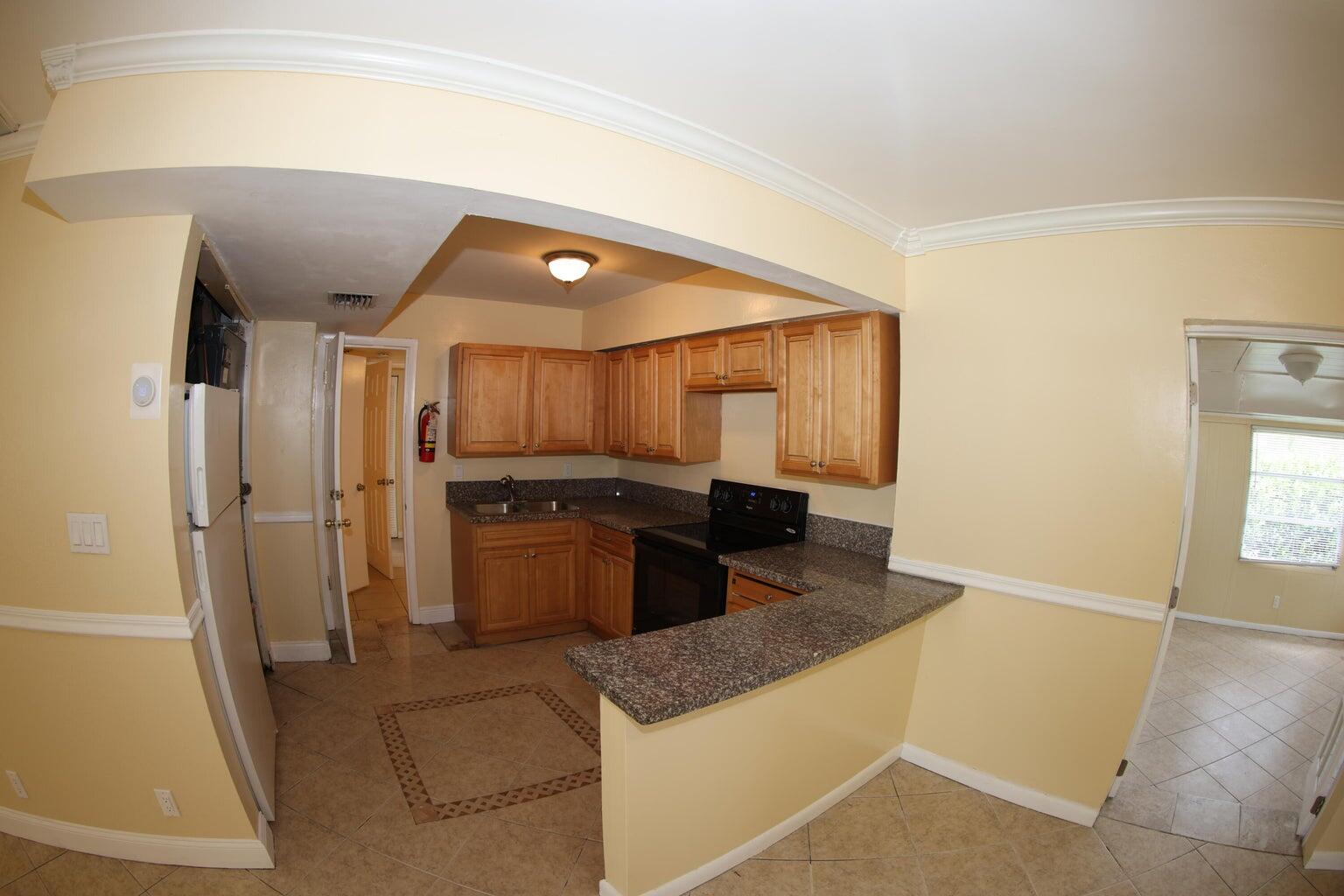 181 East Copans Road Pompano Beach, FL 33064 - Photo 4 of 11 a large kitchen with a stove and a refrigerator