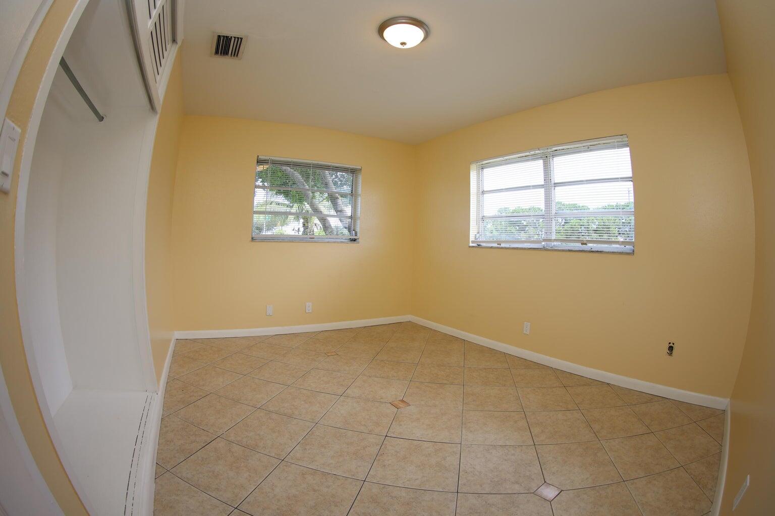 181 East Copans Road Pompano Beach, FL 33064 - Photo 6 of 11 an empty room with windows
