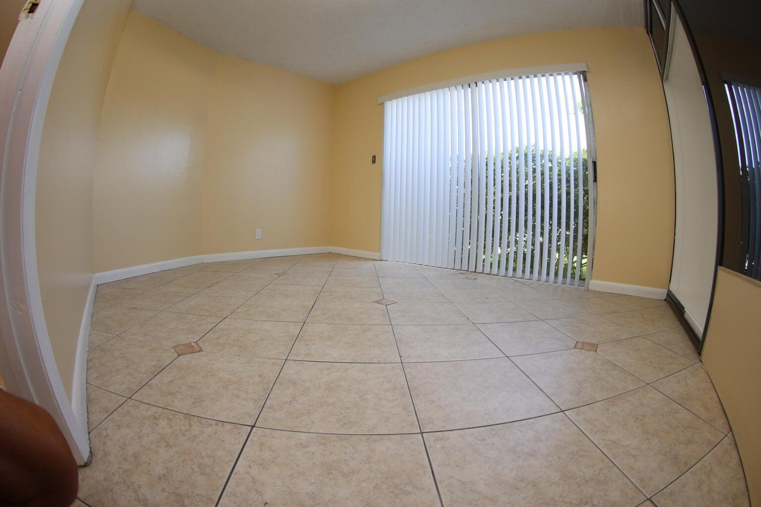 181 East Copans Road Pompano Beach, FL 33064 - Photo 8 of 11 a view of a livingroom with an empty space and a window