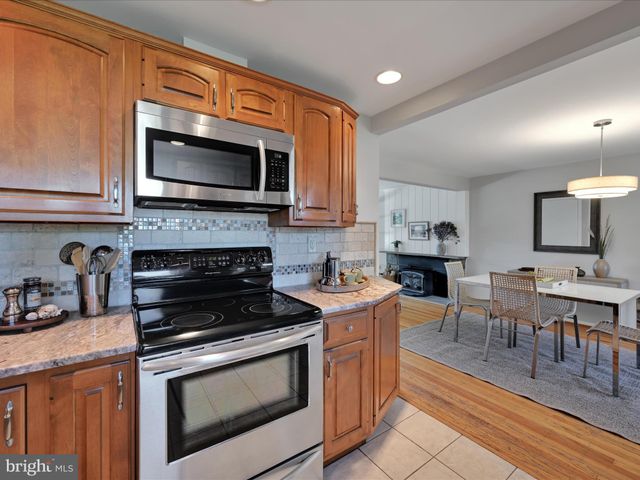 a kitchen with a stove microwave and sink