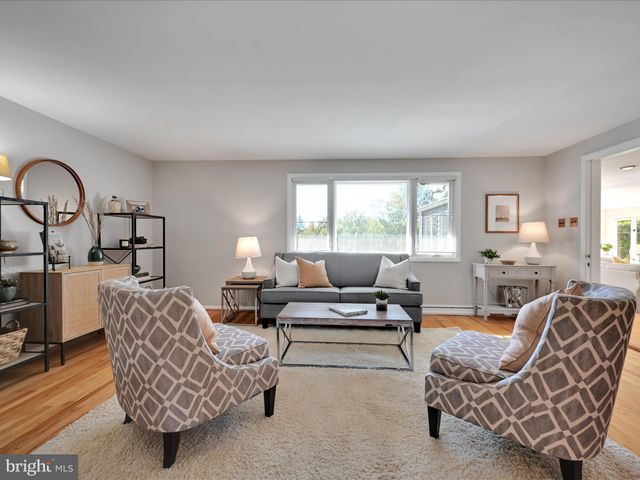 a living room with furniture a couch and potted plant