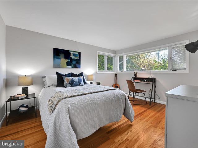 a bed room with a bed and a chair