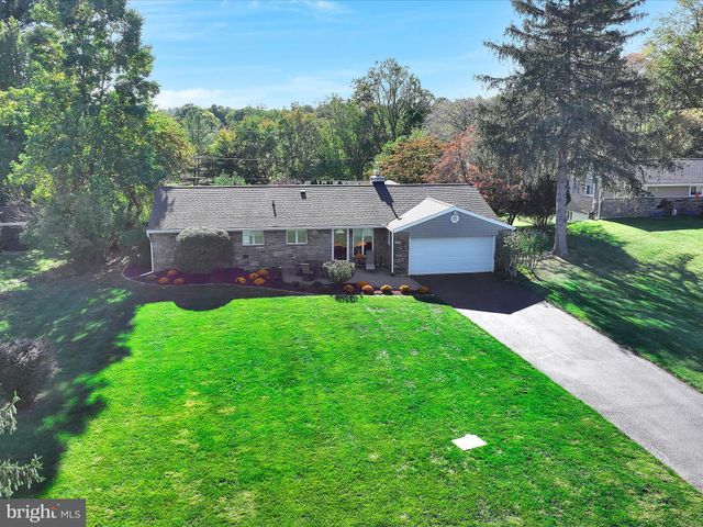 a aerial view of a house with a big yard plants and large trees