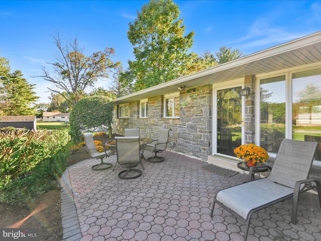 a backyard of a house with outdoor seating