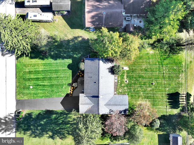 an aerial view of a house with a yard basket ball court and outdoor seating