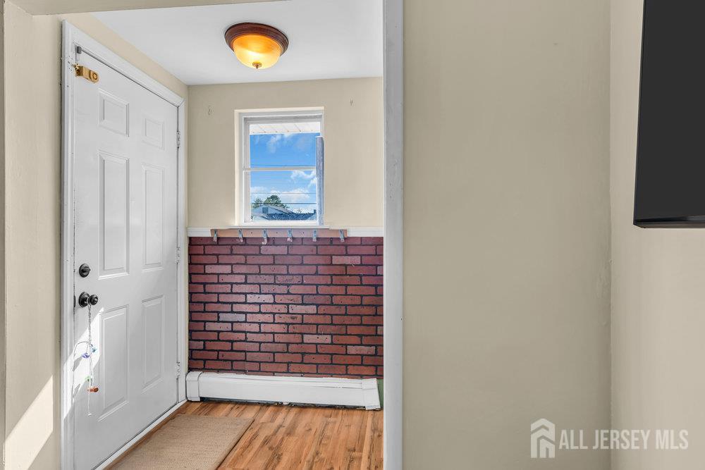 73 Webb Drive Fords, NJ 08863 - Photo 13 of 65 a view of a hallway with wooden floor and a bathroom
