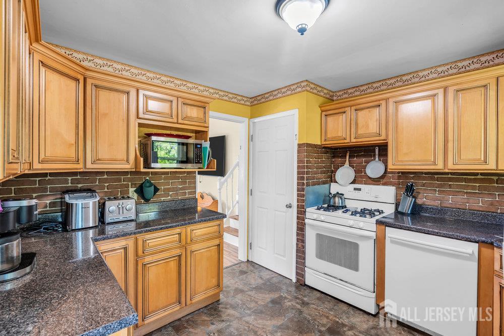 73 Webb Drive Fords, NJ 08863 - Photo 23 of 65 a kitchen with stainless steel appliances granite countertop a stove a sink and a microwave
