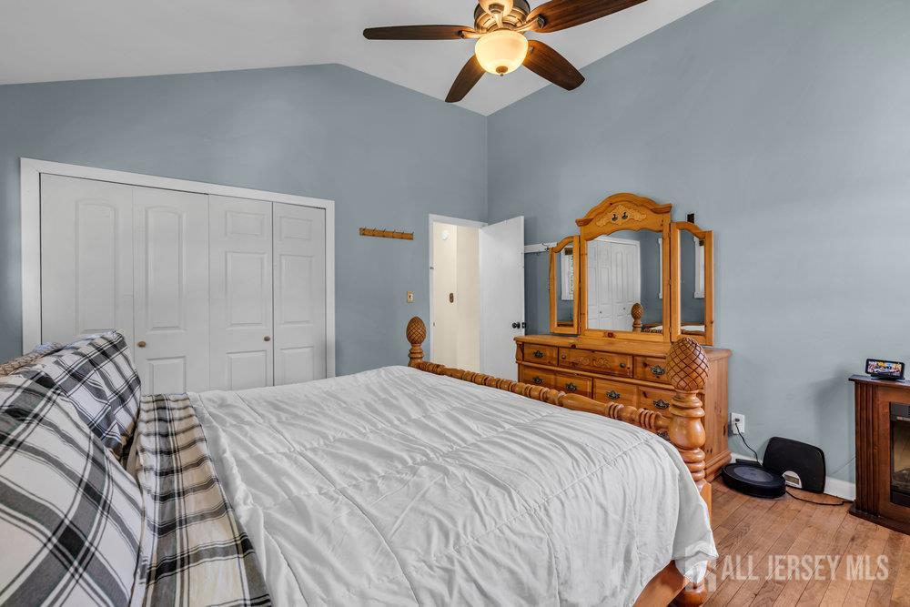 73 Webb Drive Fords, NJ 08863 - Photo 30 of 65 a bedroom with a bed and a chandelier