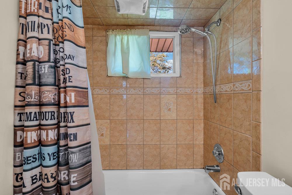 73 Webb Drive Fords, NJ 08863 - Photo 33 of 65 a bathroom with a bathtub and a shower