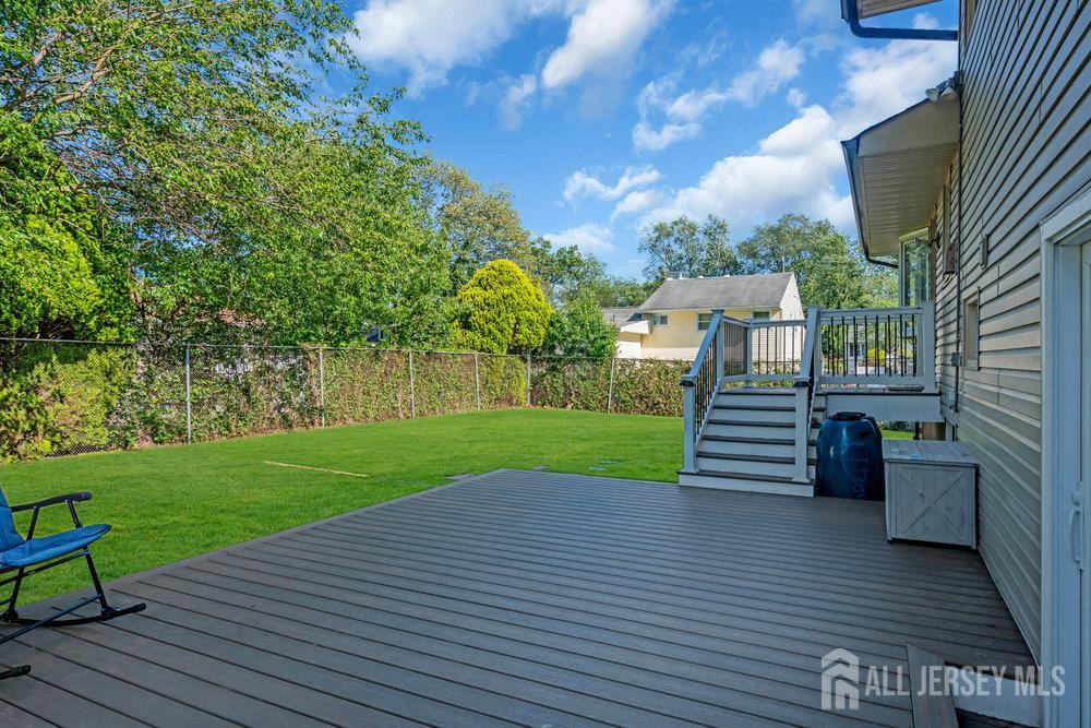 73 Webb Drive Fords, NJ 08863 - Photo 43 of 65 a view of a deck with chair and wooden floor