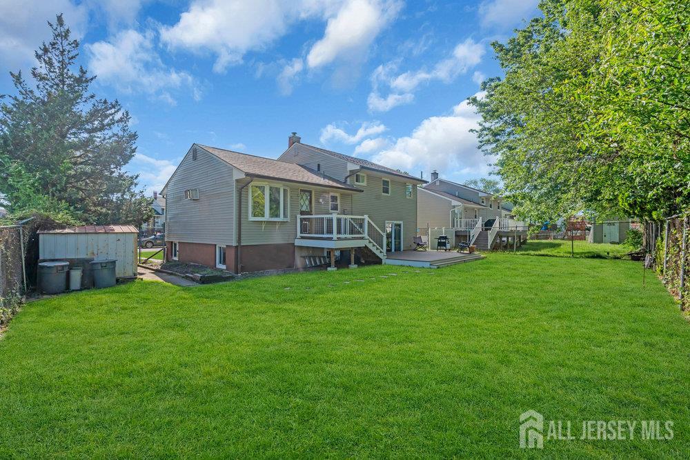 73 Webb Drive Fords, NJ 08863 - Photo 45 of 65 a backyard of a house with wooden fence and large trees