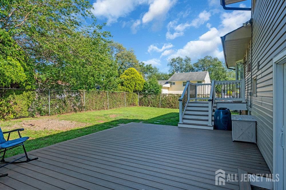 73 Webb Drive Fords, NJ 08863 - Photo 62 of 65 a view of a deck with chair and wooden fence