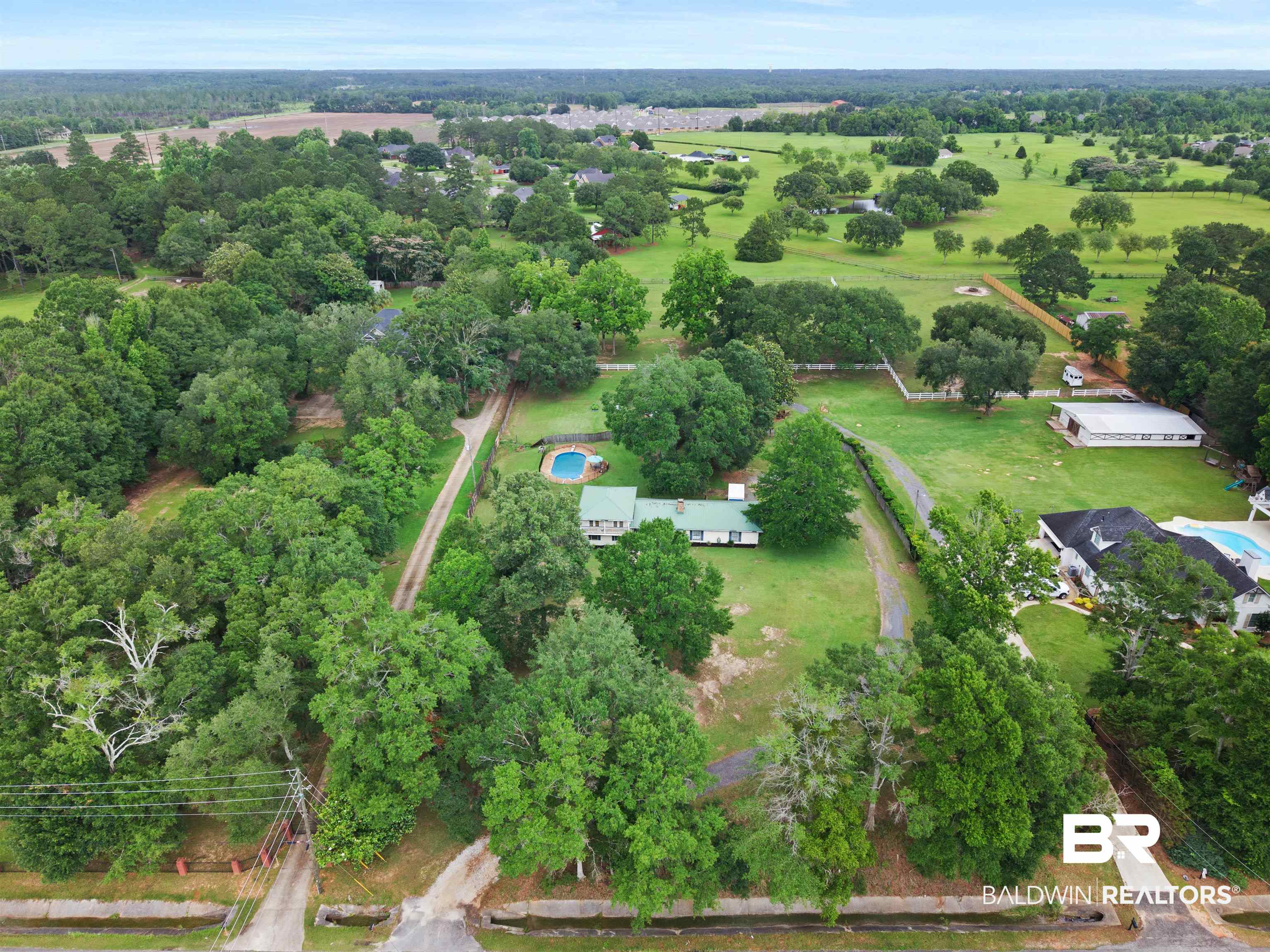 10420 Johnson Road South Mobile, AL 36695 - Photo 65 of 75 Expansive property featuring a central residence, a swimming pool, and extensive green space with mature trees