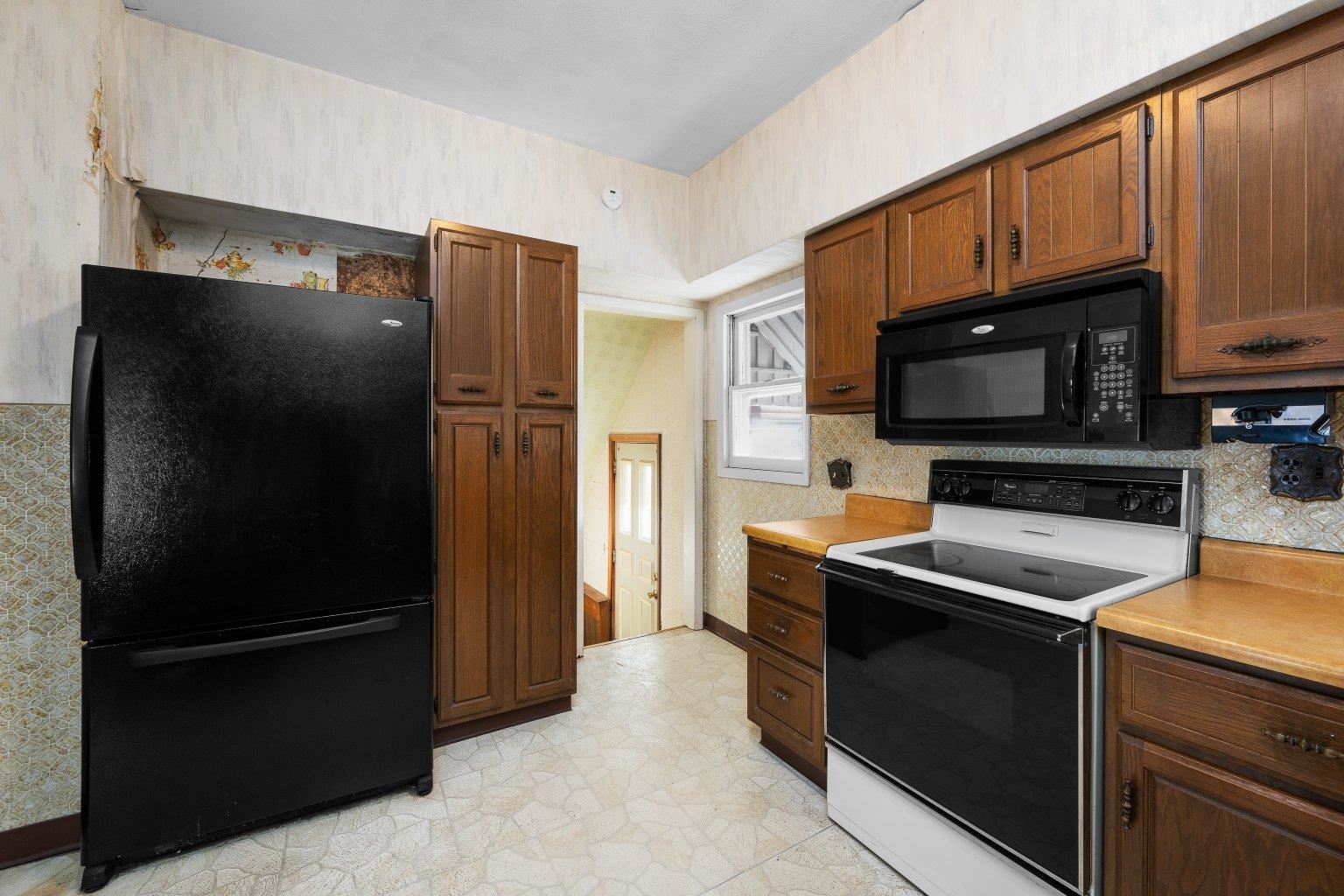 5108 6th Avenue Moline, IL 61265 - Photo 11 of 23 a kitchen with stainless steel appliances granite countertop a refrigerator stove and microwave