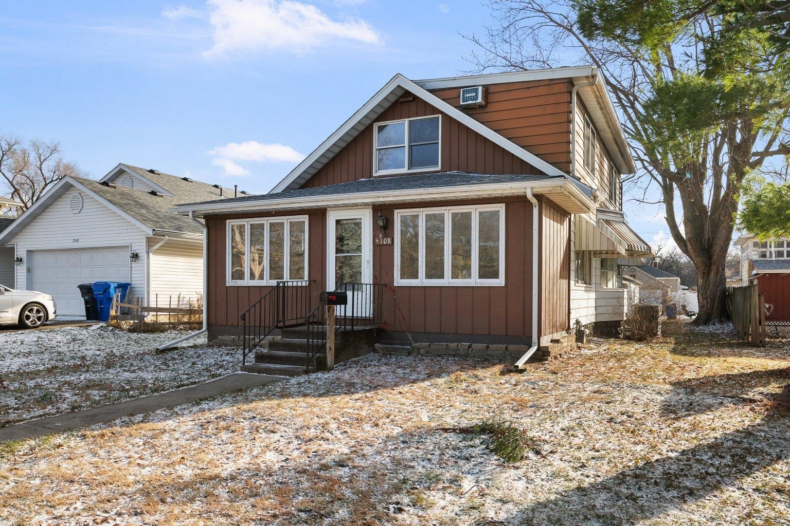 5108 6th Avenue Moline, IL 61265 - Photo 2 of 23 a front view of a house with a yard covered in snow