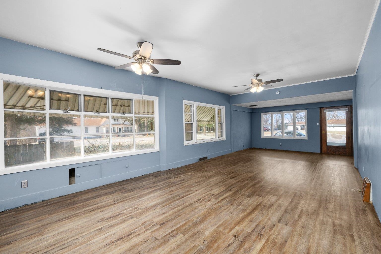 5108 6th Avenue Moline, IL 61265 - Photo 5 of 23 a view of an empty room with a window and wooden floor