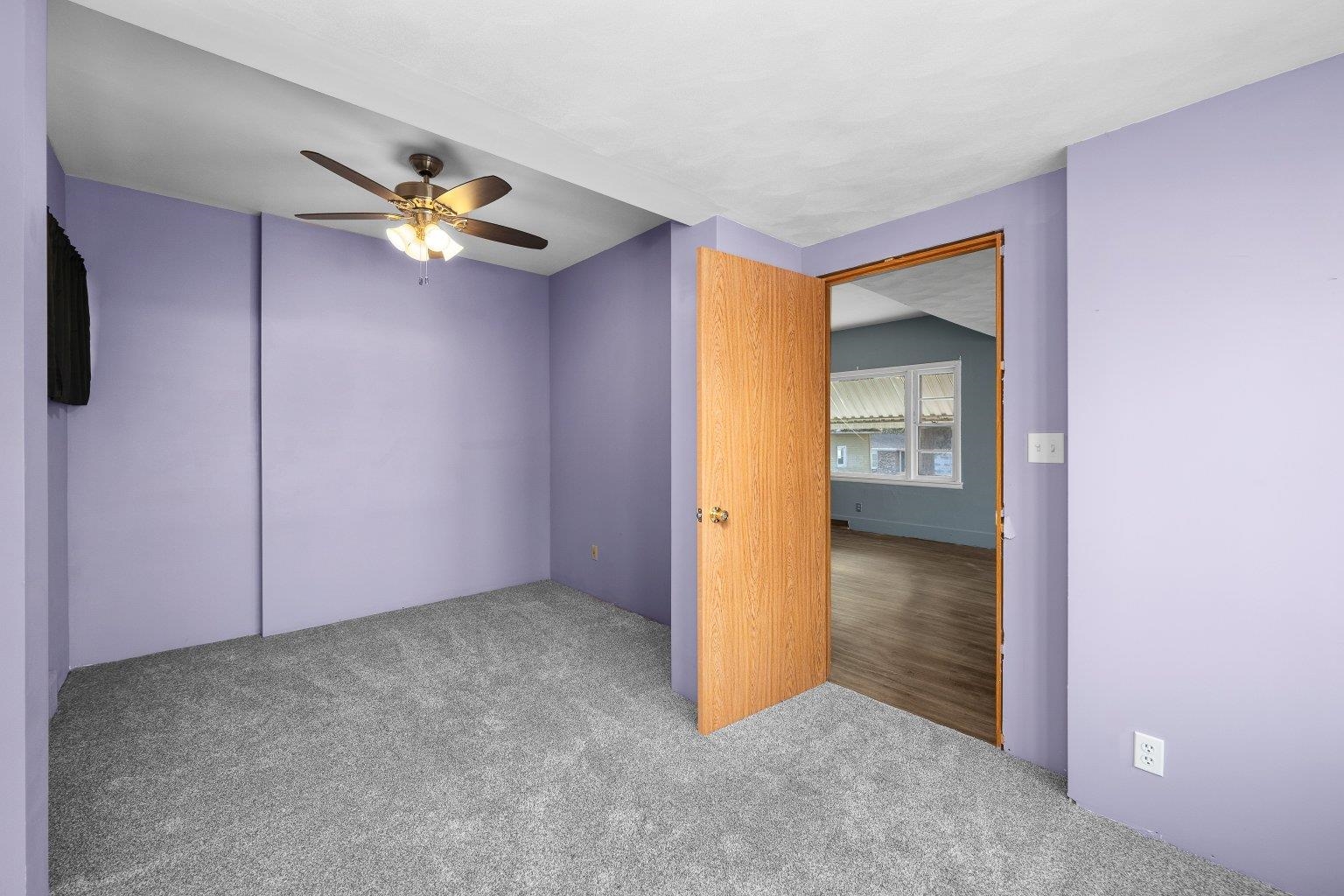 5108 6th Avenue Moline, IL 61265 - Photo 8 of 23 an empty room with closet and a chandelier fan