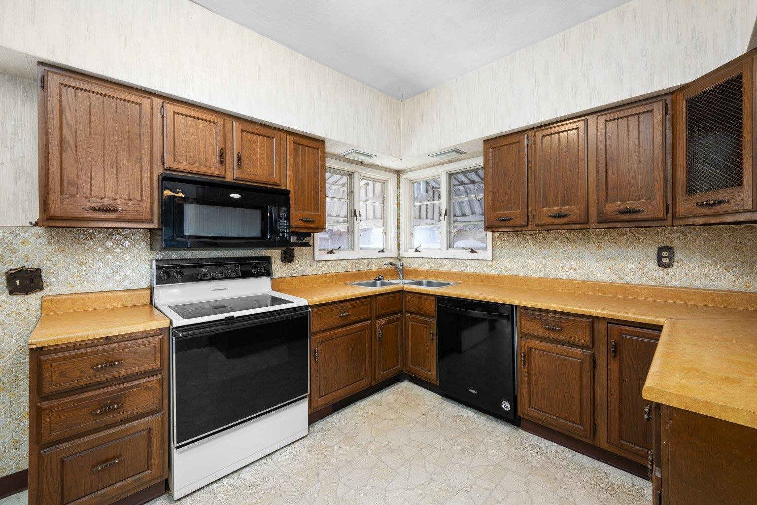 5108 6th Avenue Moline, IL 61265 - Photo 9 of 23 a kitchen with wooden cabinets and a stove top oven