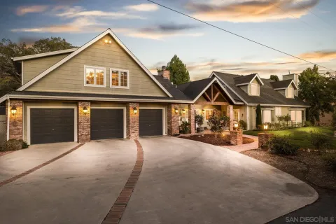 a view of a house with backyard porch and sitting area