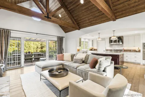 a living room with furniture a fireplace and a large window