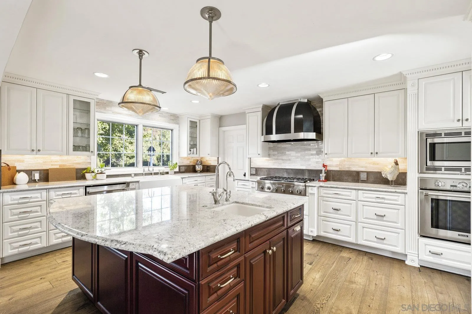 20455 Elfin Forest Road Escondido, CA 92029 - Photo 15 of 50 a kitchen with kitchen island granite countertop a stove a sink a oven and wooden cabinets with wooden floor