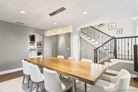a view of a dining room with a table and chairs