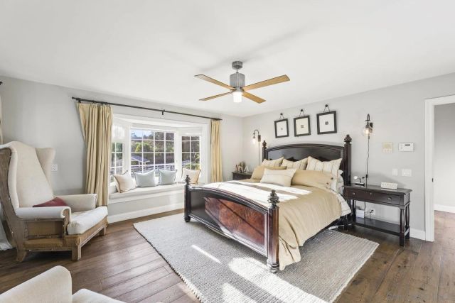 a bedroom with a bed and a ceiling fan