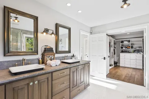 a bathroom with a tub a sink and a large window