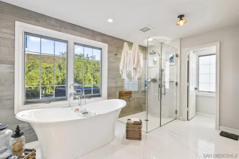 a bathroom with a double vanity sink toilet mirror and tub