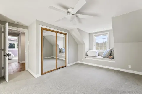 a living room with furniture ceiling fan and a window