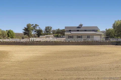 a front view of a house with swimming pool having outdoor seating