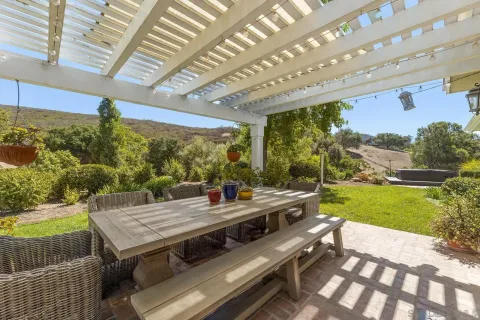 a view of a house with a yard and sitting area
