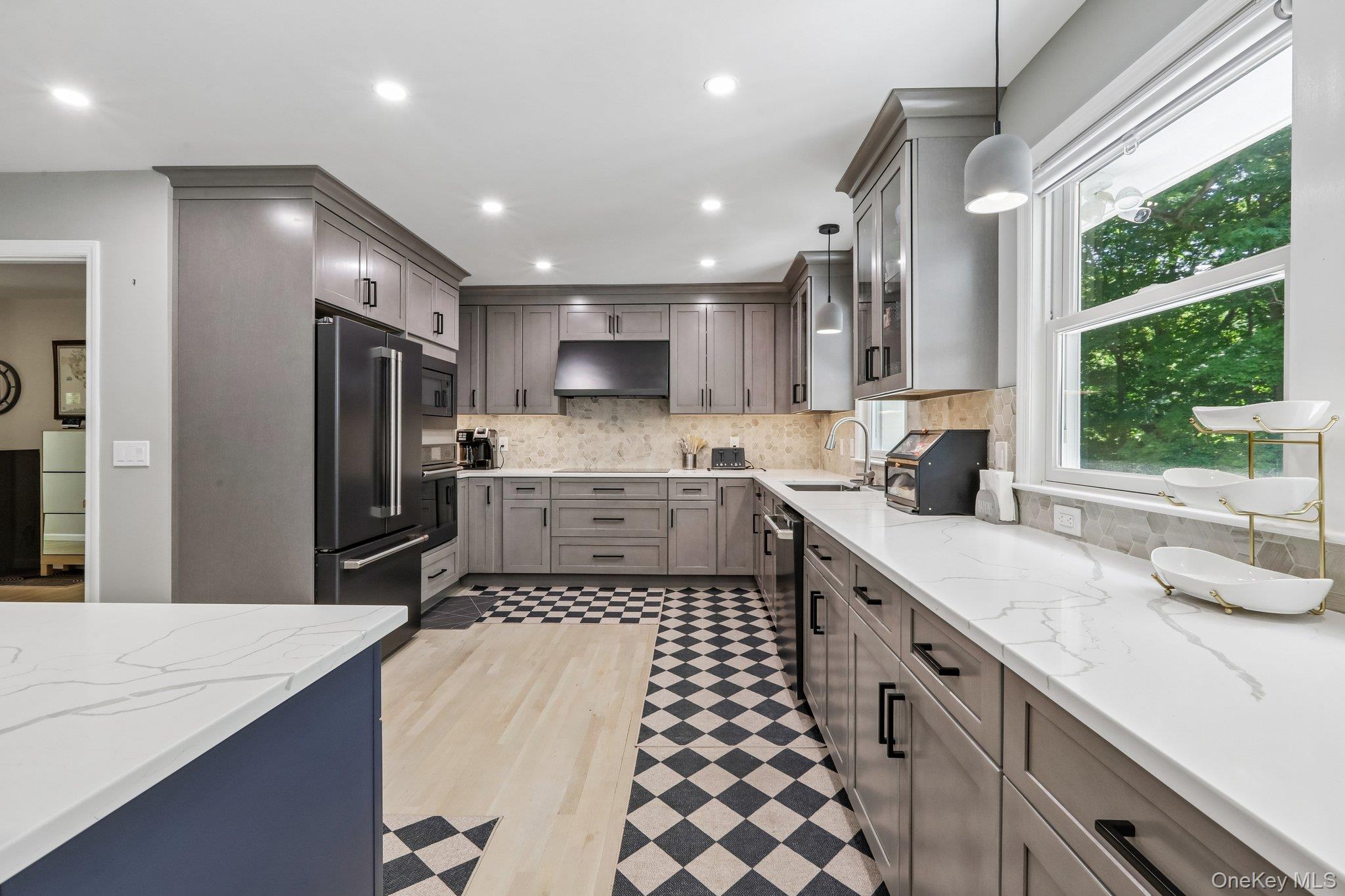 62 Mohegan Road Larchmont, NY 10538 - Photo 25 of 46 a kitchen with stainless steel appliances kitchen island granite countertop a sink refrigerator and cabinets