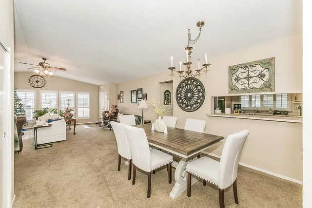 a dining room with furniture a rug and a chandelier