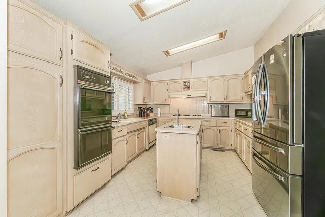 a kitchen with cabinets and stainless steel appliances