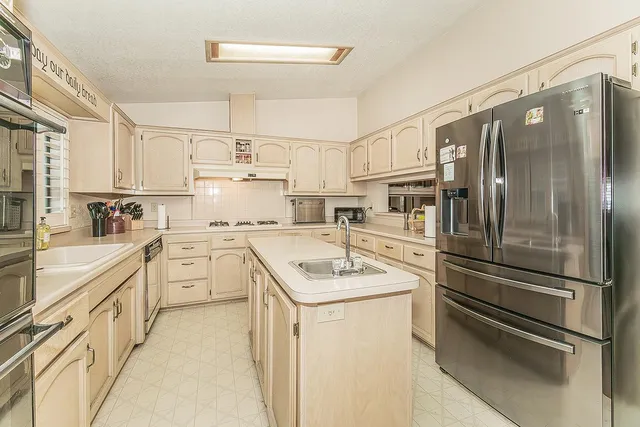 a kitchen with cabinets stainless steel appliances and a counter top space