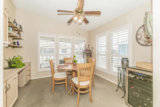 a spacious bedroom with a bed and ceiling fan