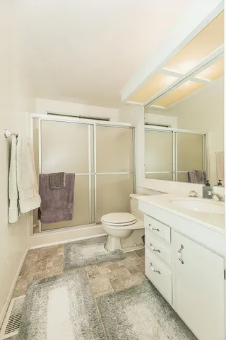 a view of a kitchen with white cabinets