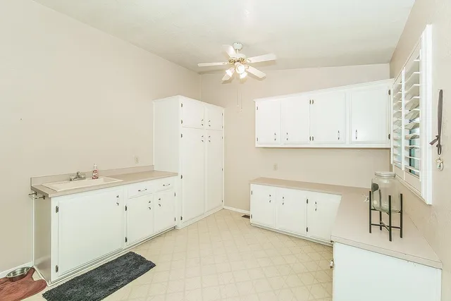 a utility room with cabinets washer and dryer